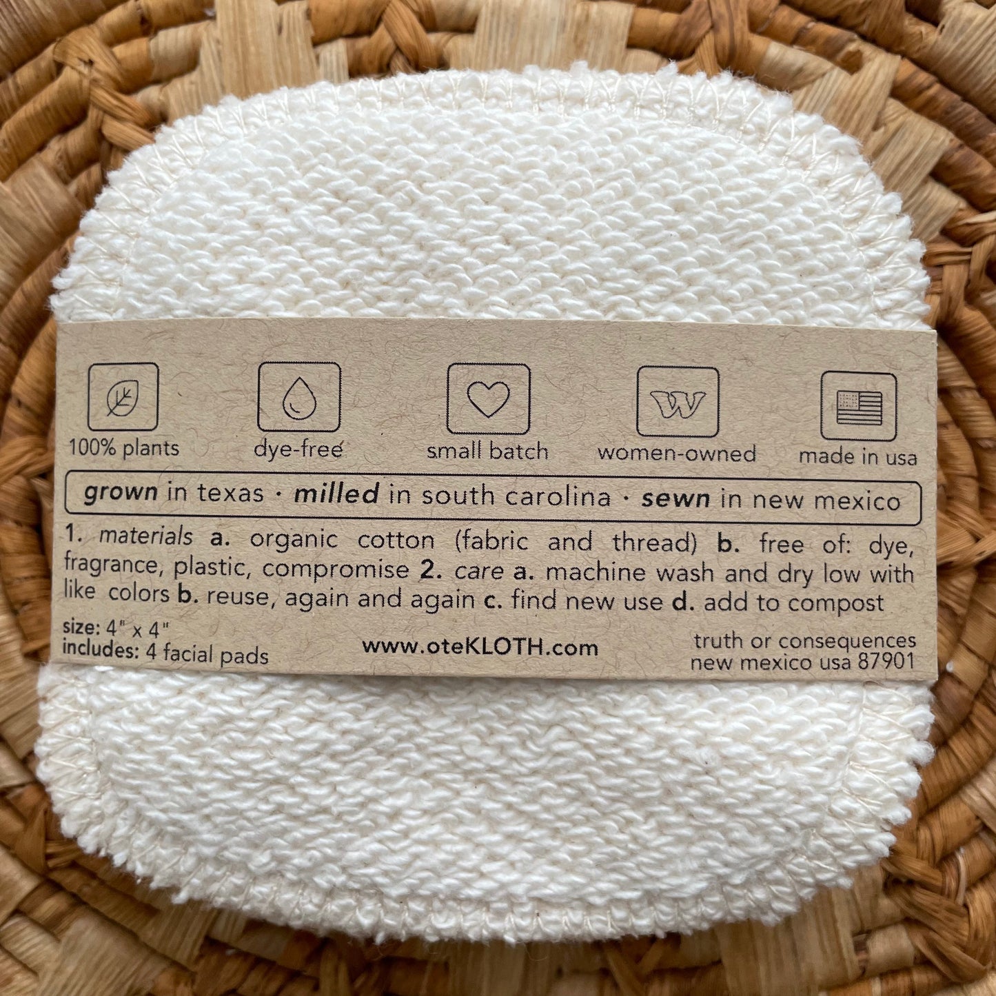 White facial pad with a label on a woven background