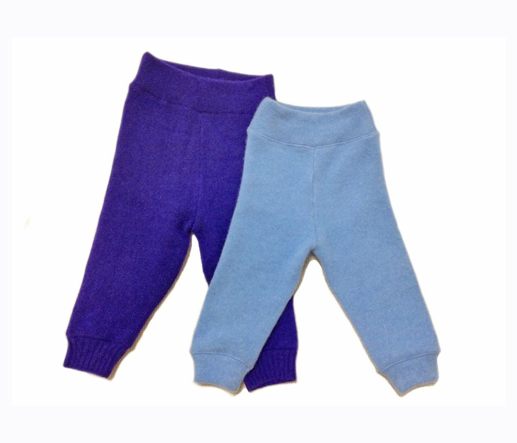Purple and blue baby pants on a white background