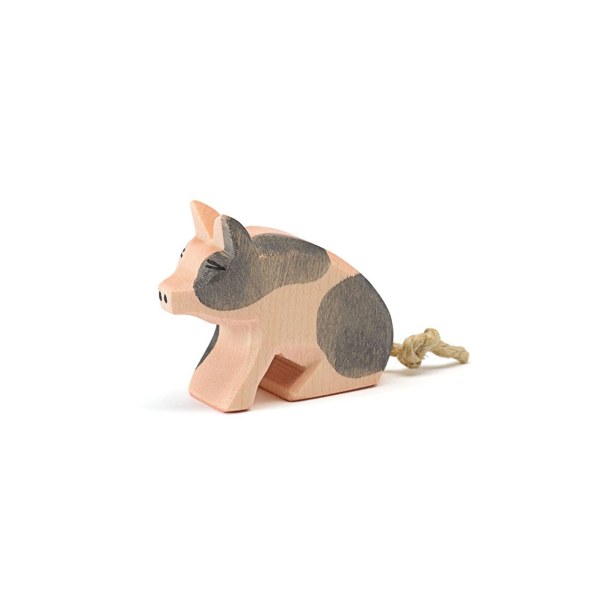 Spotted piglet sitting by Ostheimer