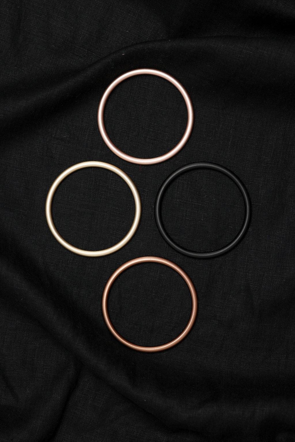 Three circular objects on a black fabric background