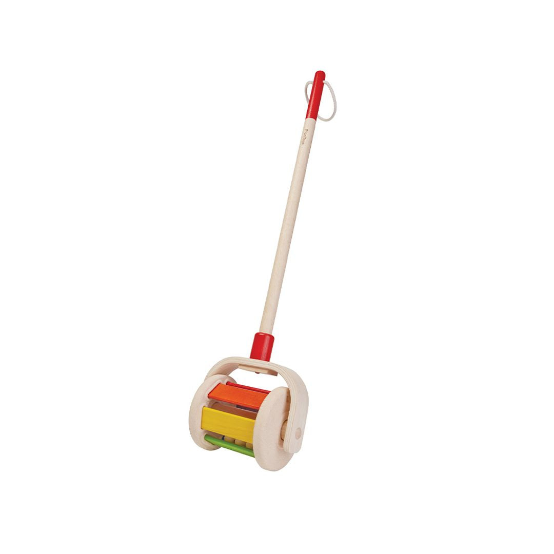 Colorful wooden toy with a handle on a white background