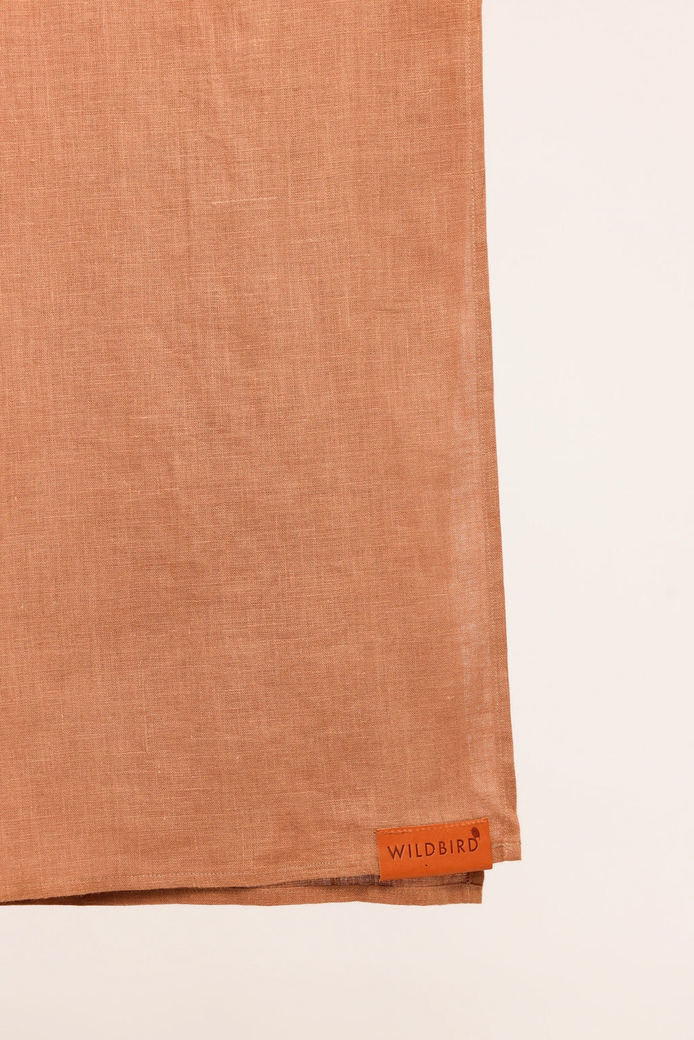 Brown fabric with a 'Wildbird' label on a light beige background
