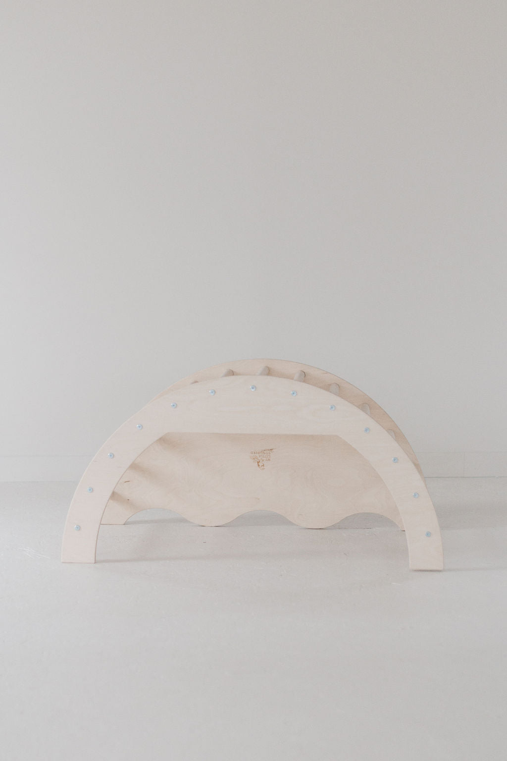 Wooden rainbow toy on a white background