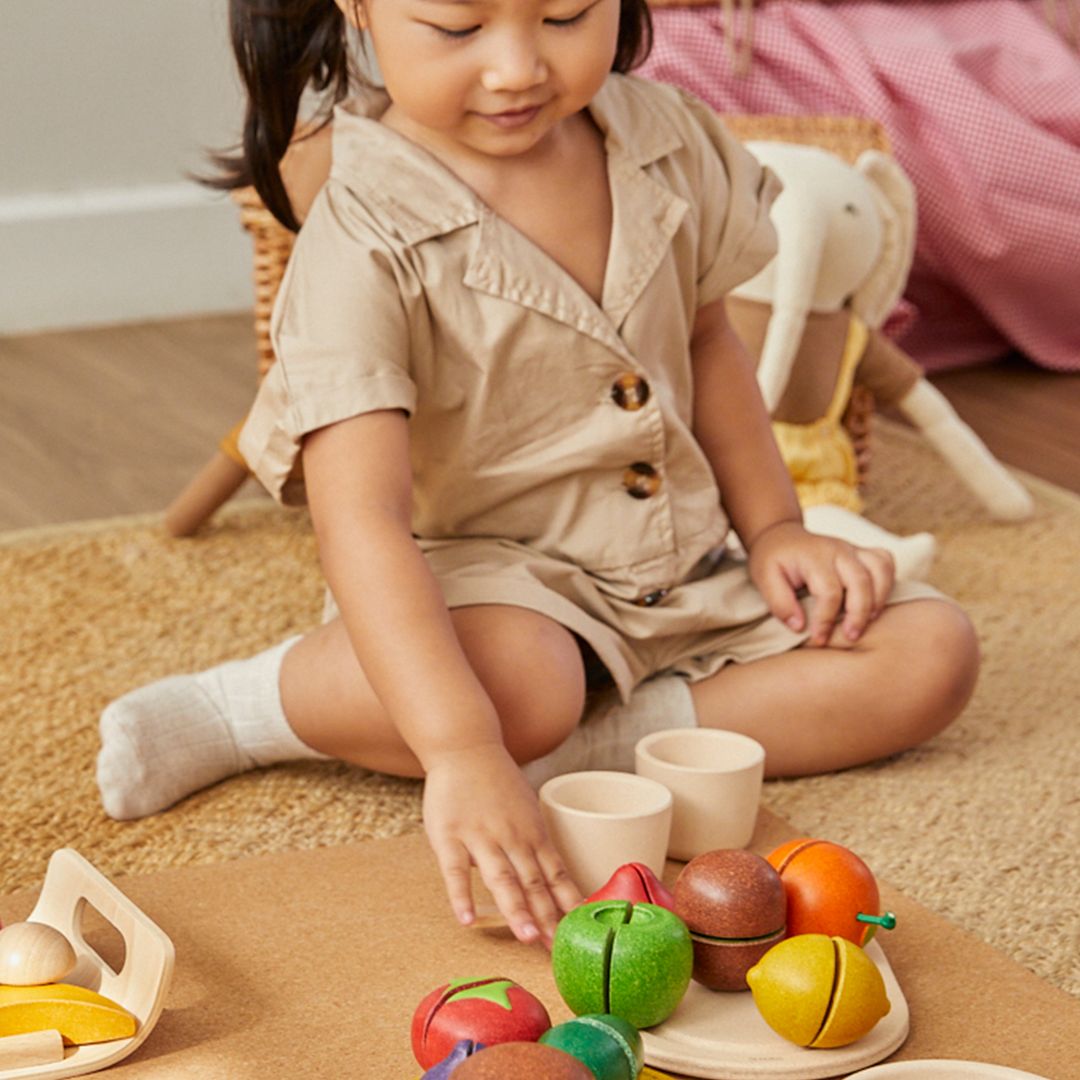 Child playing with toys on a carpeted floor