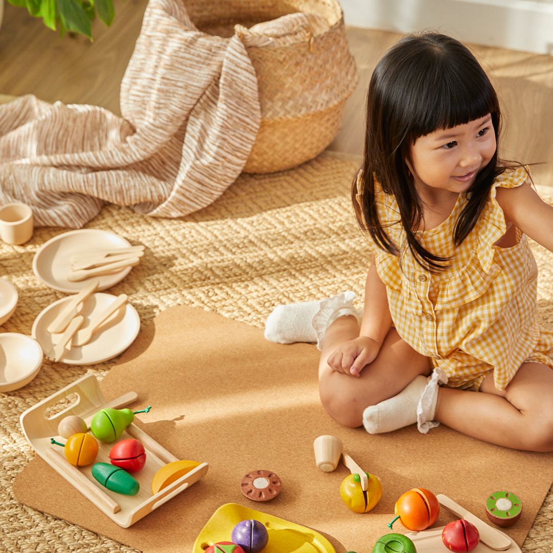 Child playing with wooden toys on a wooden floor
