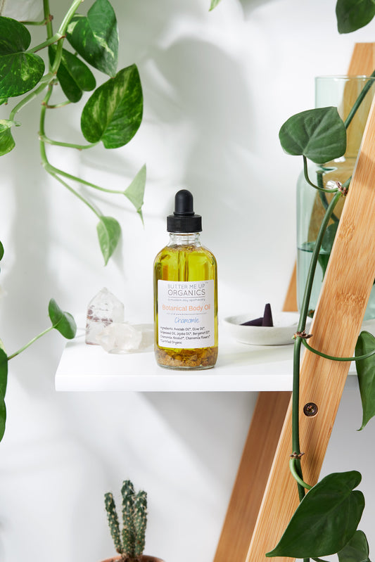 Bottle of organic skincare product on a white shelf with plants in the background