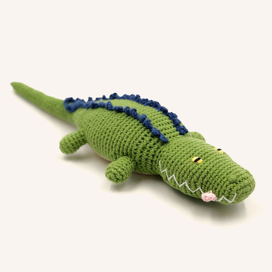 Green crocodile plush toy on a white background