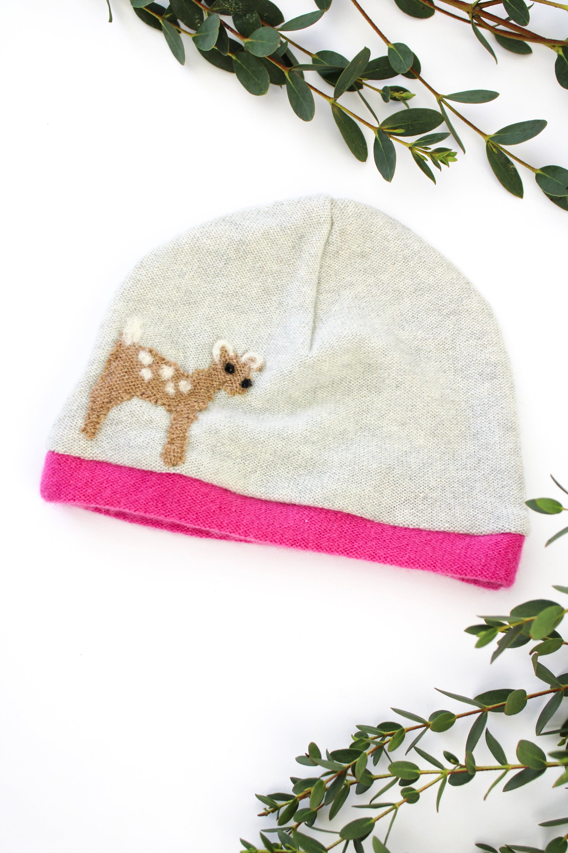 Baby hat with deer design on a white background