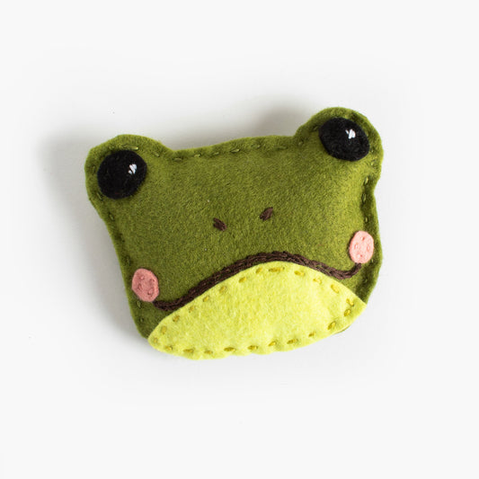 Felt frog toy on a white background