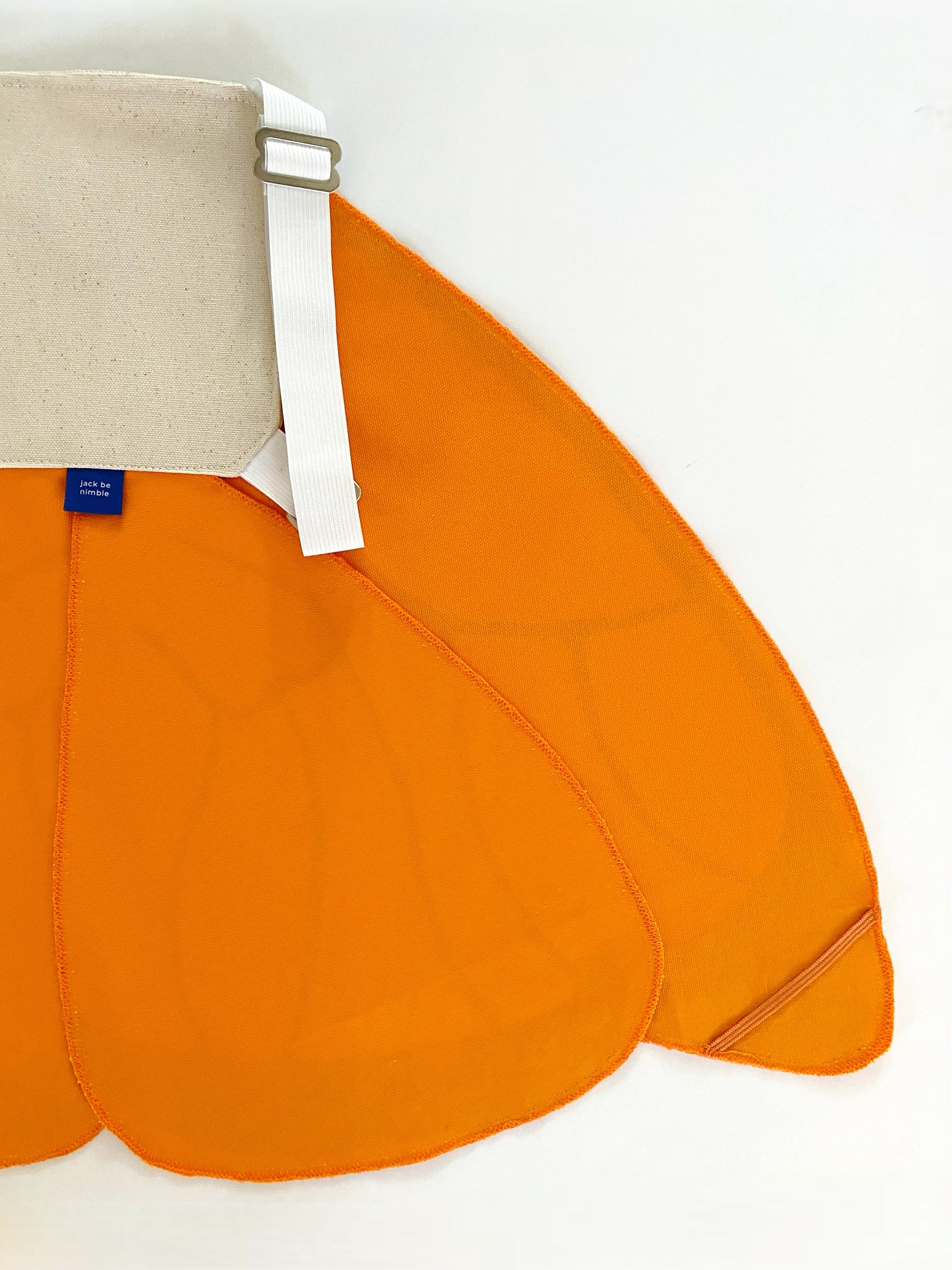 Orange bag with a beige strap on a white background
