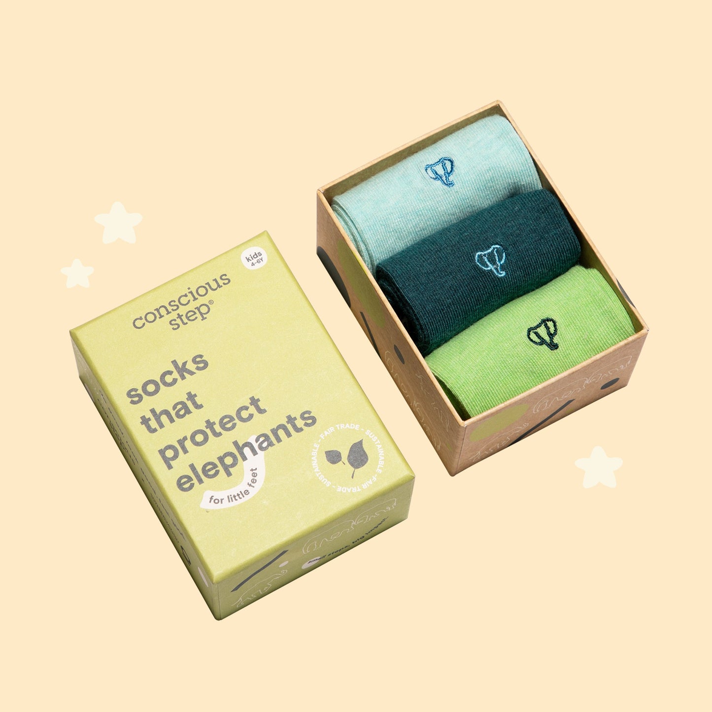 Two pairs of socks in a box with a 'conscious step' label on a beige background