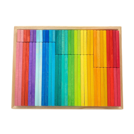 Set of colorful wooden blocks arranged in a rainbow pattern on a white background