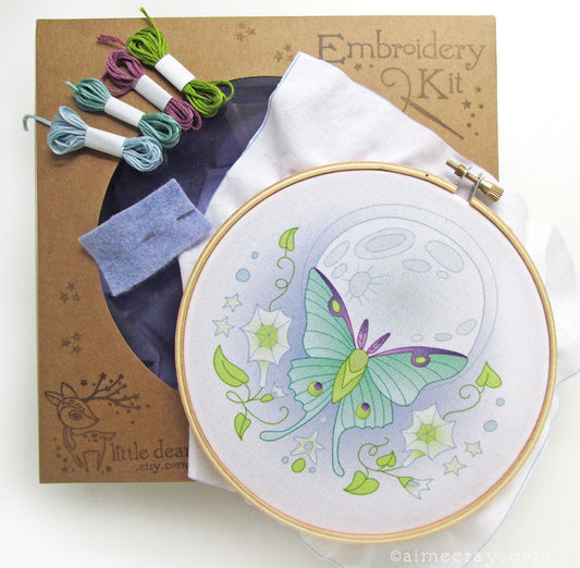 Embroidery kit with hoop, thread, and butterfly design on a white background