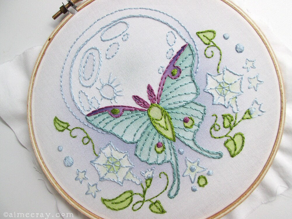 Embroidery hoop with a detailed butterfly design on a white background