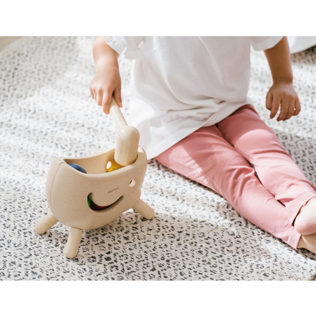 Child playing with a toy on a carpeted floor