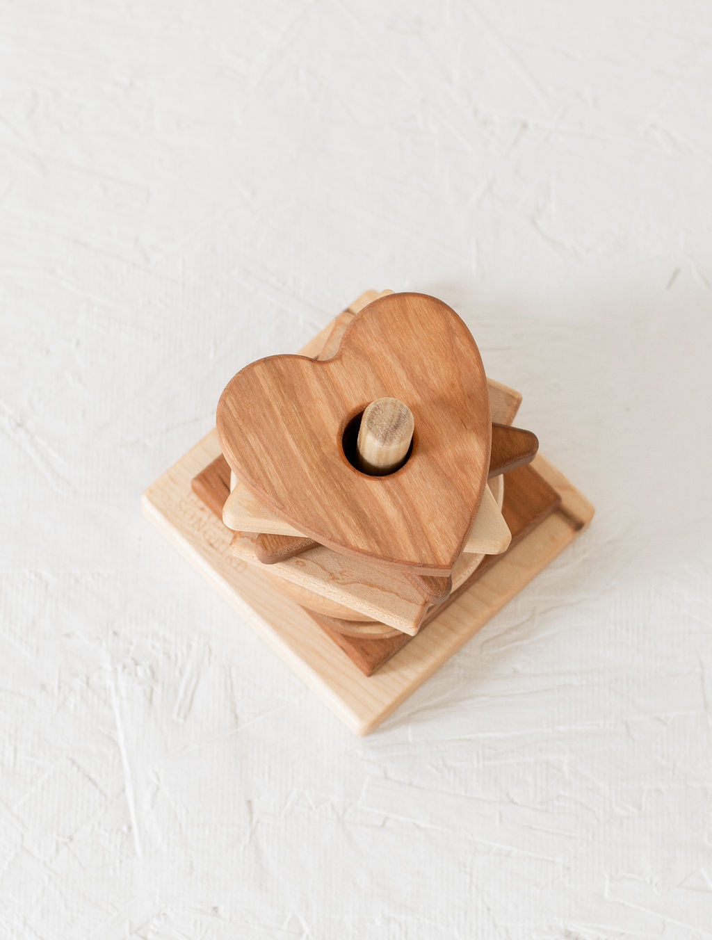 Wooden heart-shaped block on a white surface