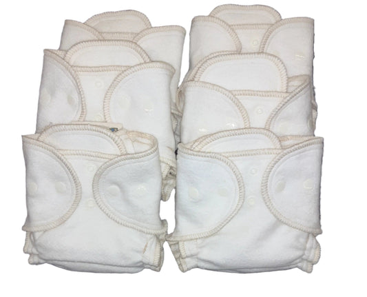 Set of white cloth diapers with snap closures on a white background