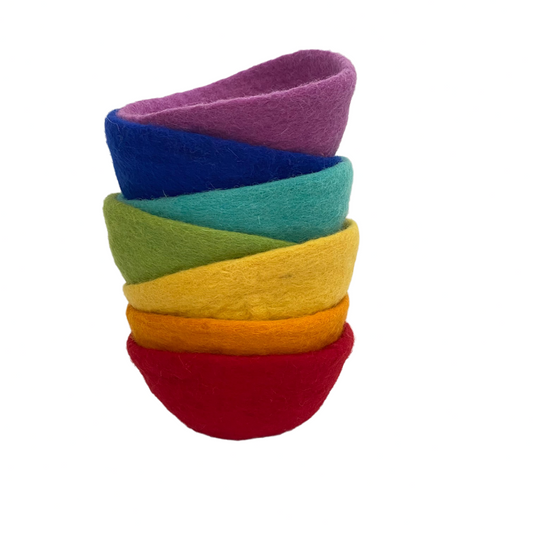 Stack of colorful felt bowls on a white background