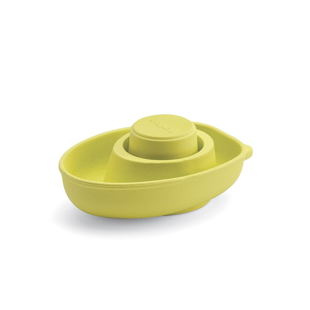 Green plastic toy boat on a white background