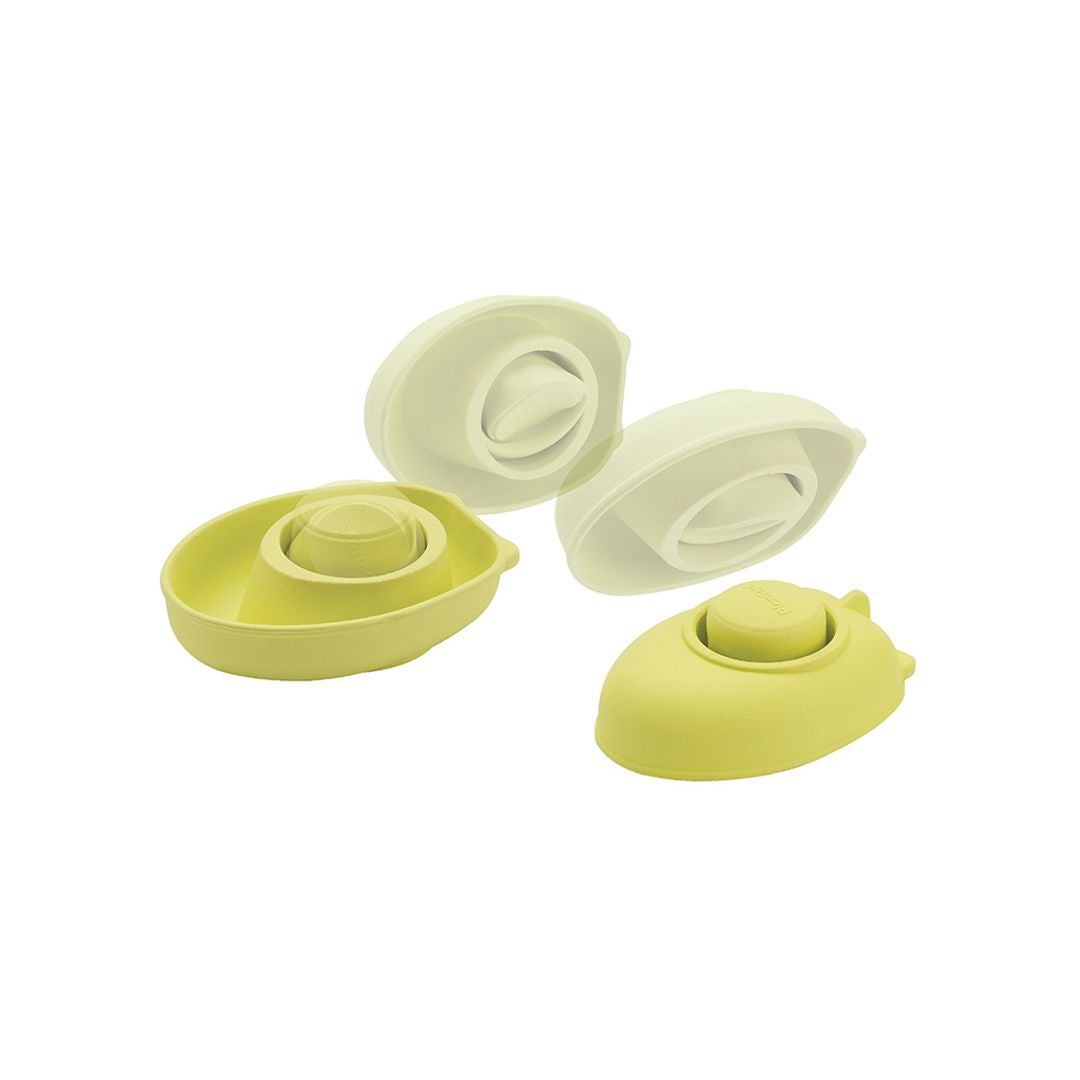 Set of green silicone boat-shaped containers on a white background