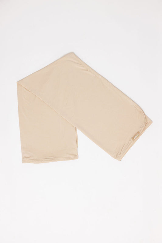 Beige fabric folded on a white background