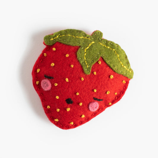 Felt strawberry with green leaves on a white background