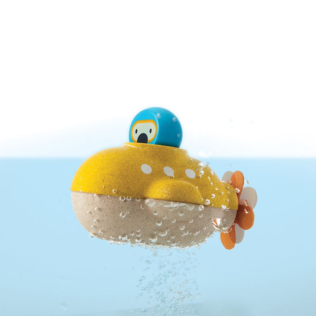 Yellow toy submarine with a blue top in water
