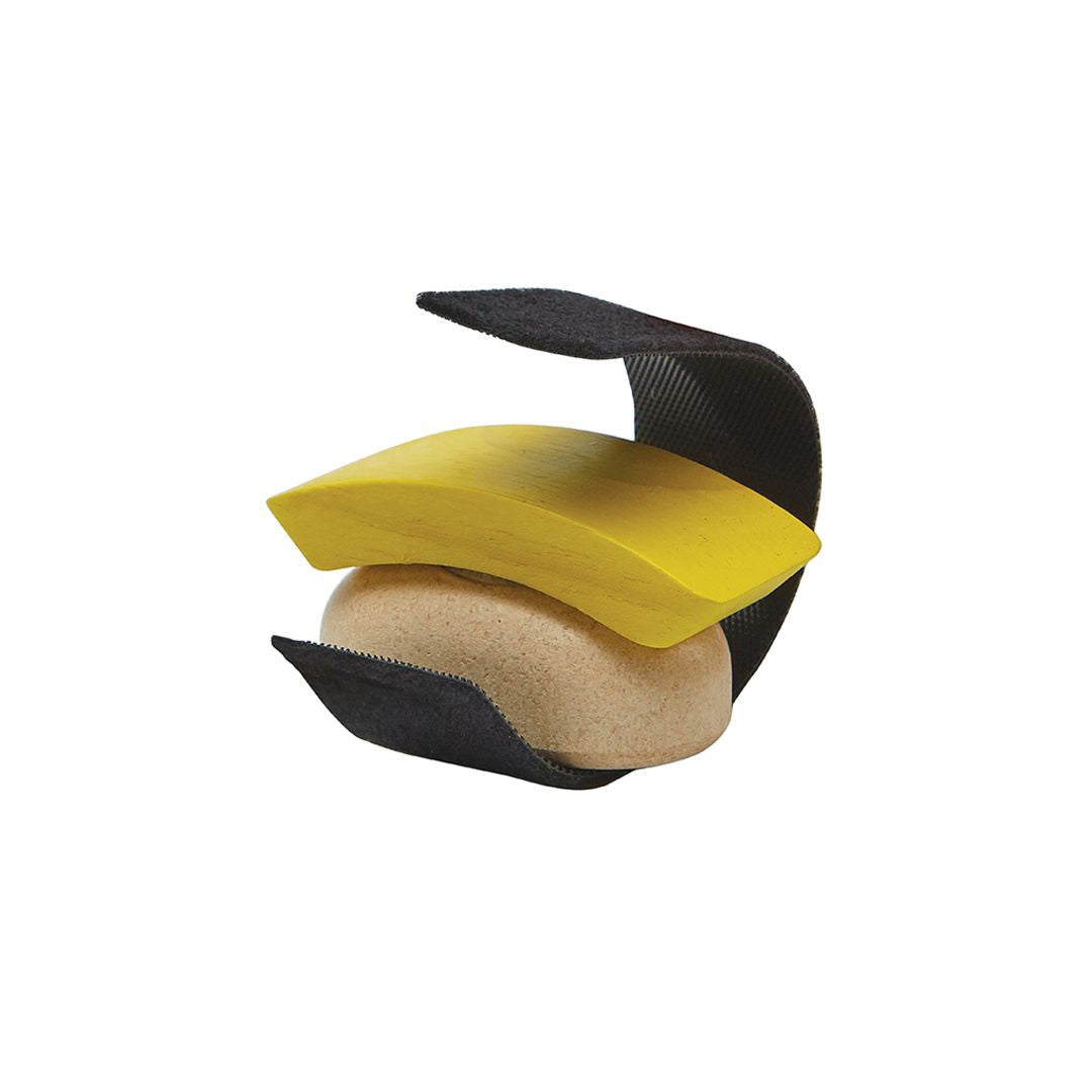 Three-tiered pet toy with yellow, black, and beige sections on a white background