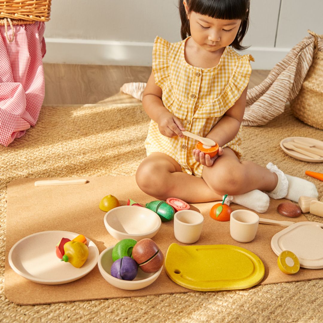 Child playing with colorful toys on a mat indoors