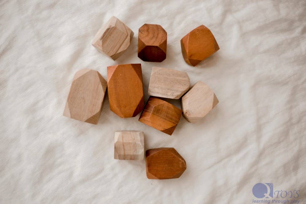 Wooden building blocks on a textured white surface