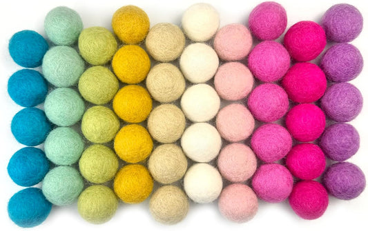 Colorful felt balls arranged in a grid on a white background