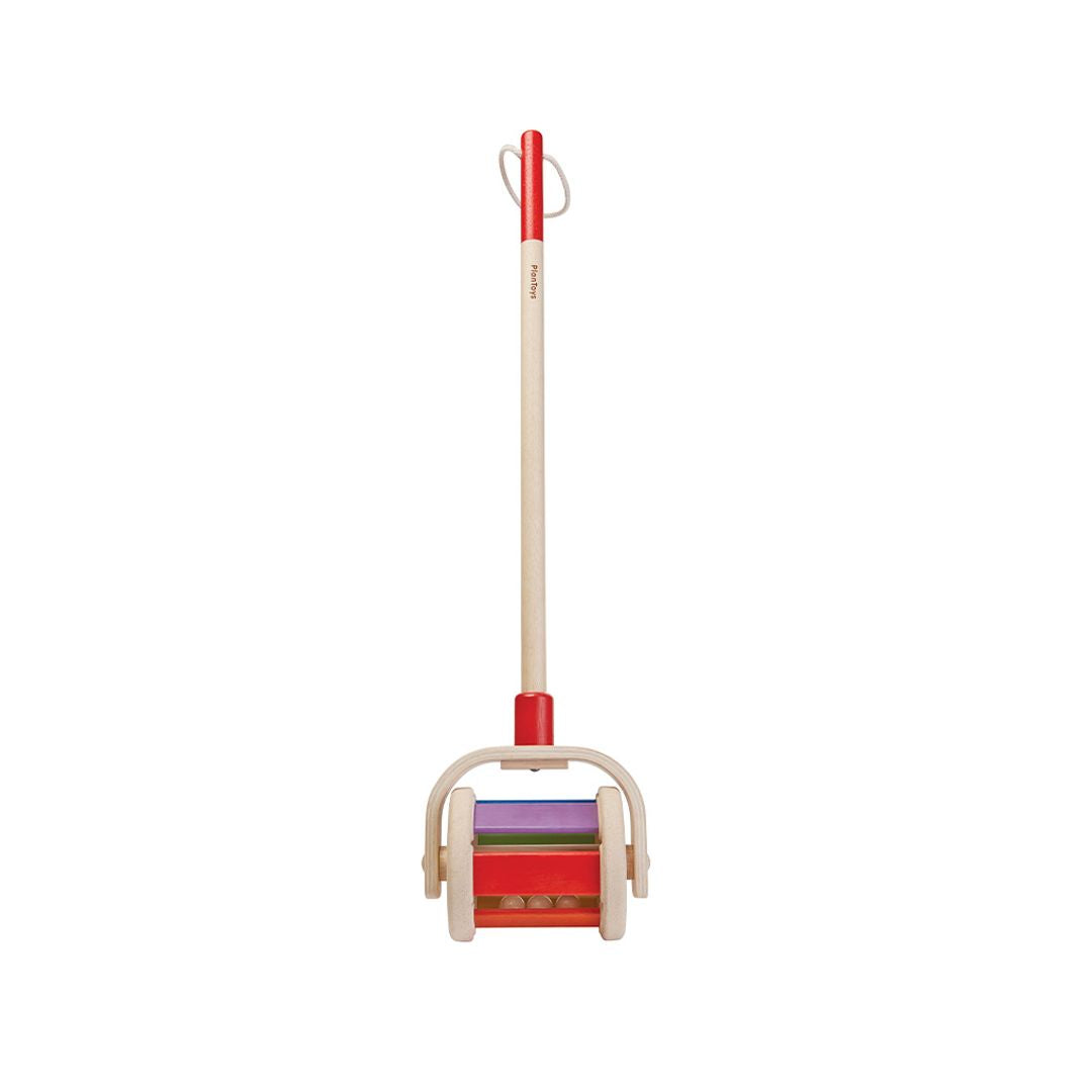 Colorful children's ski set with wooden handle on a white background