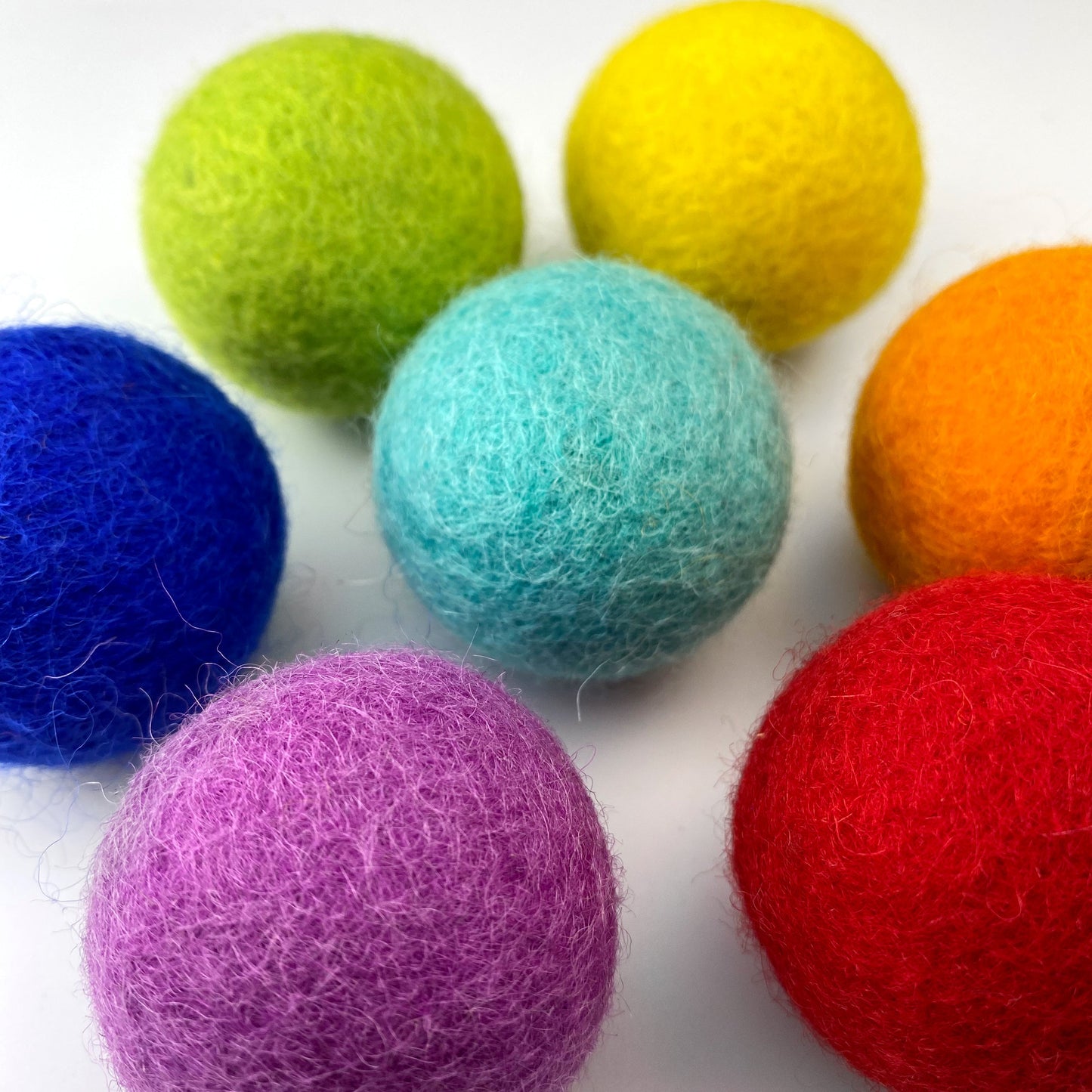 Colorful felt balls on a white background