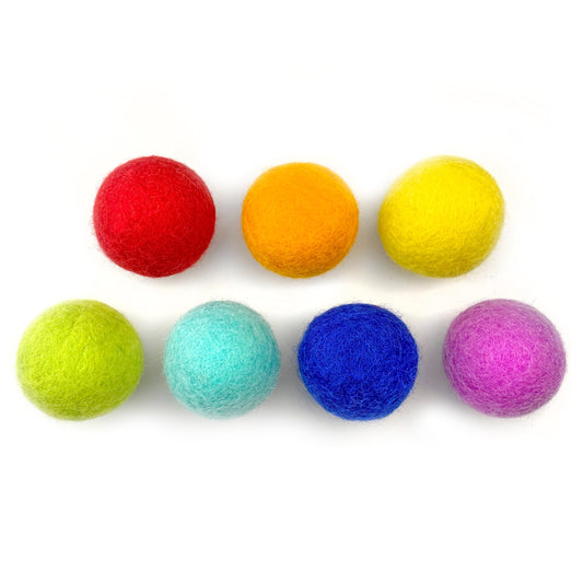 Set of colorful felt balls on a white background