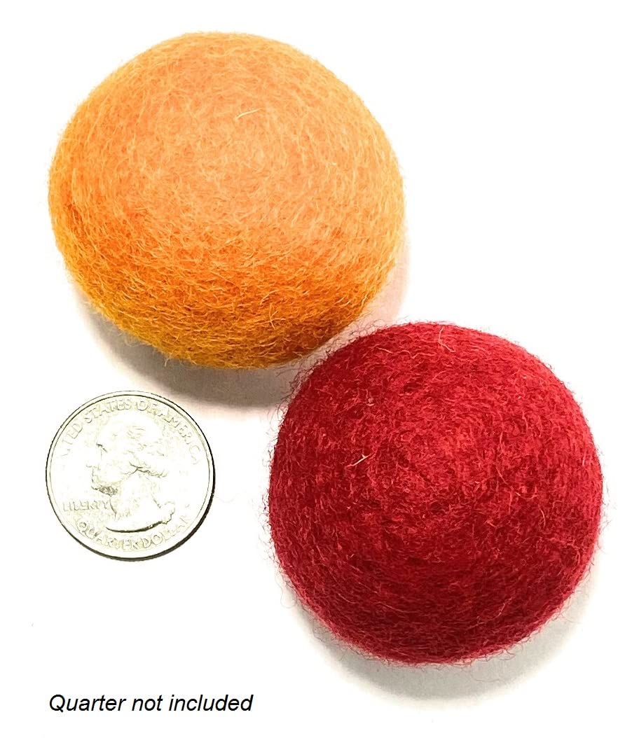 Two felt balls, one orange and one red, next to a quarter on a white background.