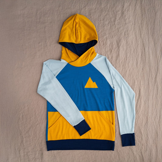 Colorful hoodie with a geometric design on a beige surface