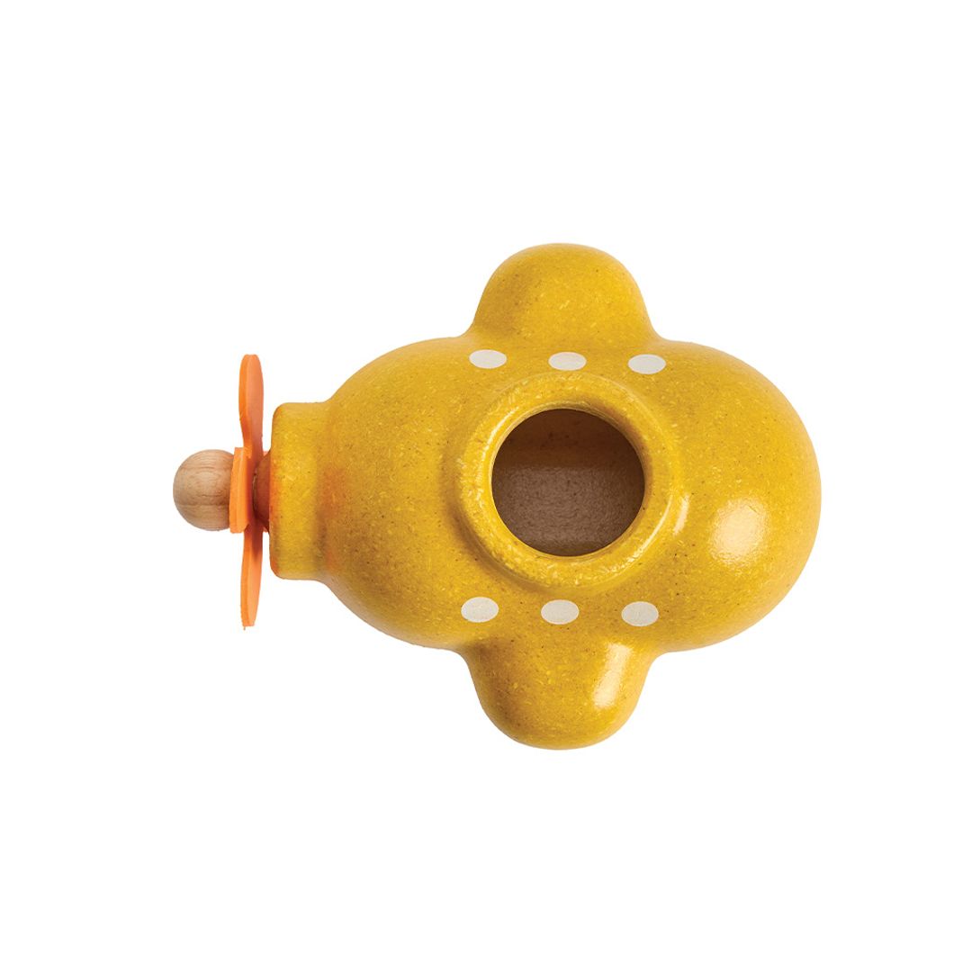 Yellow ceramic flowerpot with white dots on a white background