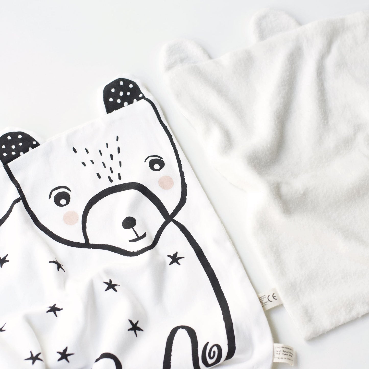 White baby blanket with black bear design on a white background