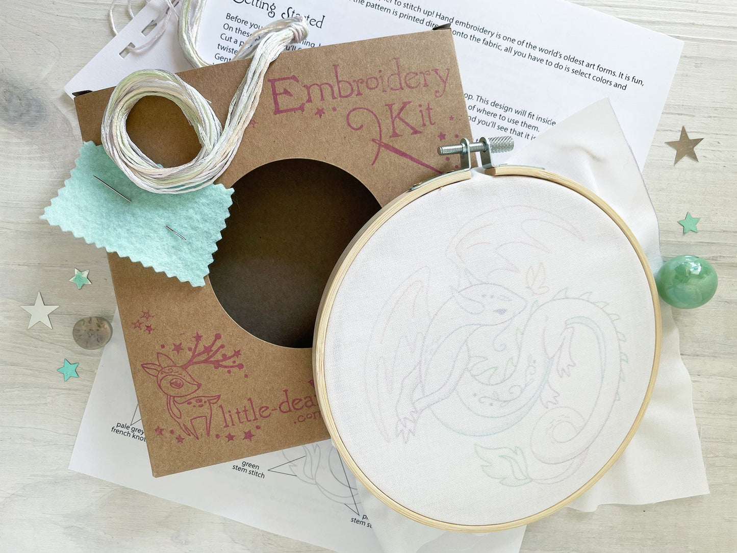 Embroidery kit with hoop and pattern on a wooden surface
