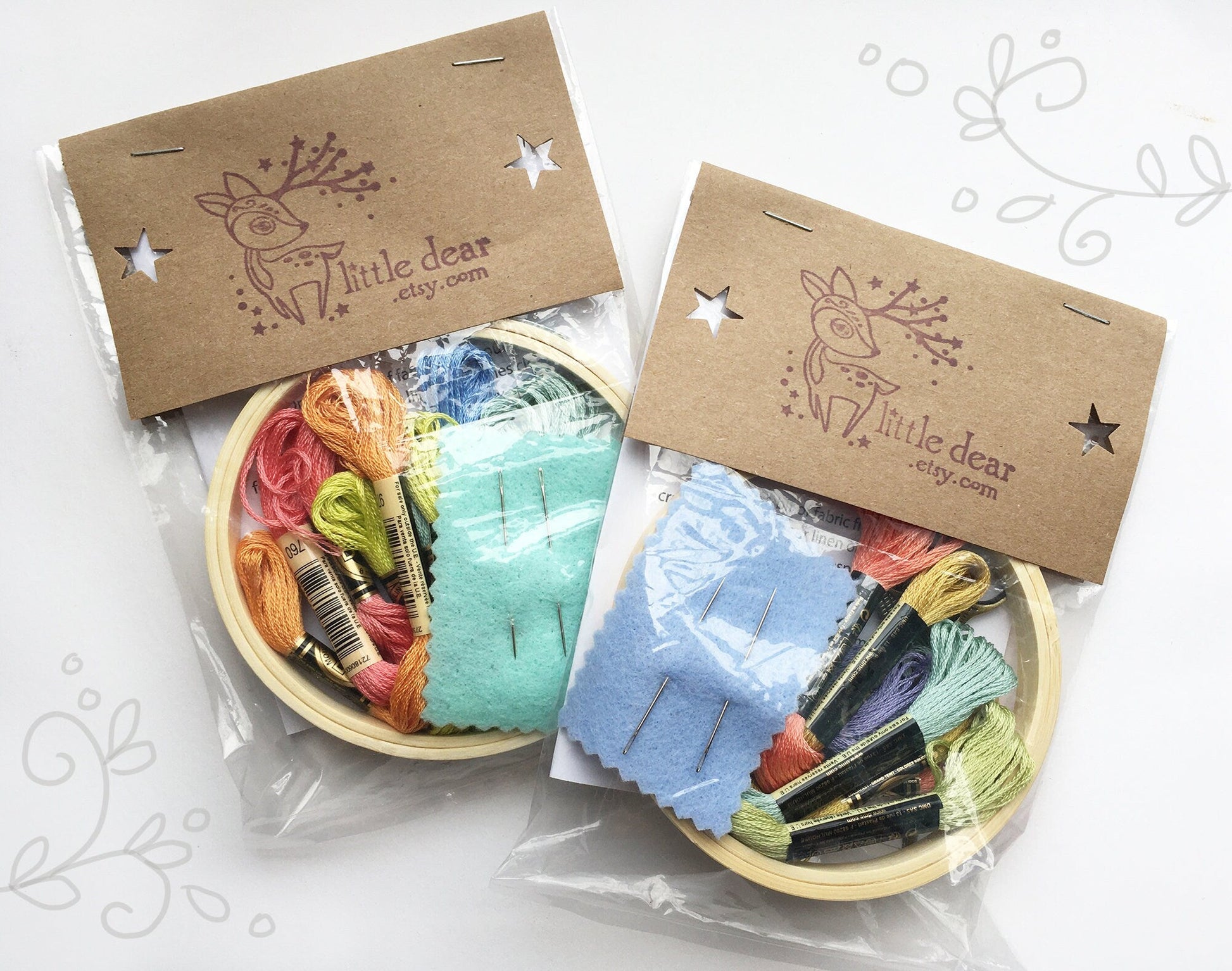 Two wooden bowls with colorful embroidery threads and fabric squares, branded 'Little Dear', on a white background.