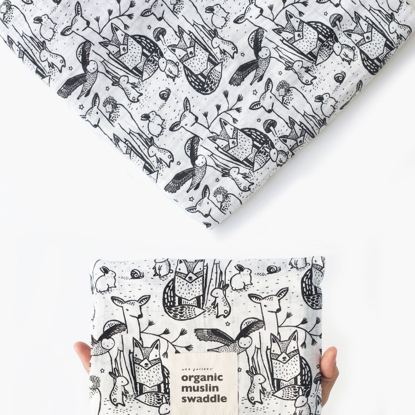 Organic muslin swaddle with black and white animal pattern on a white background