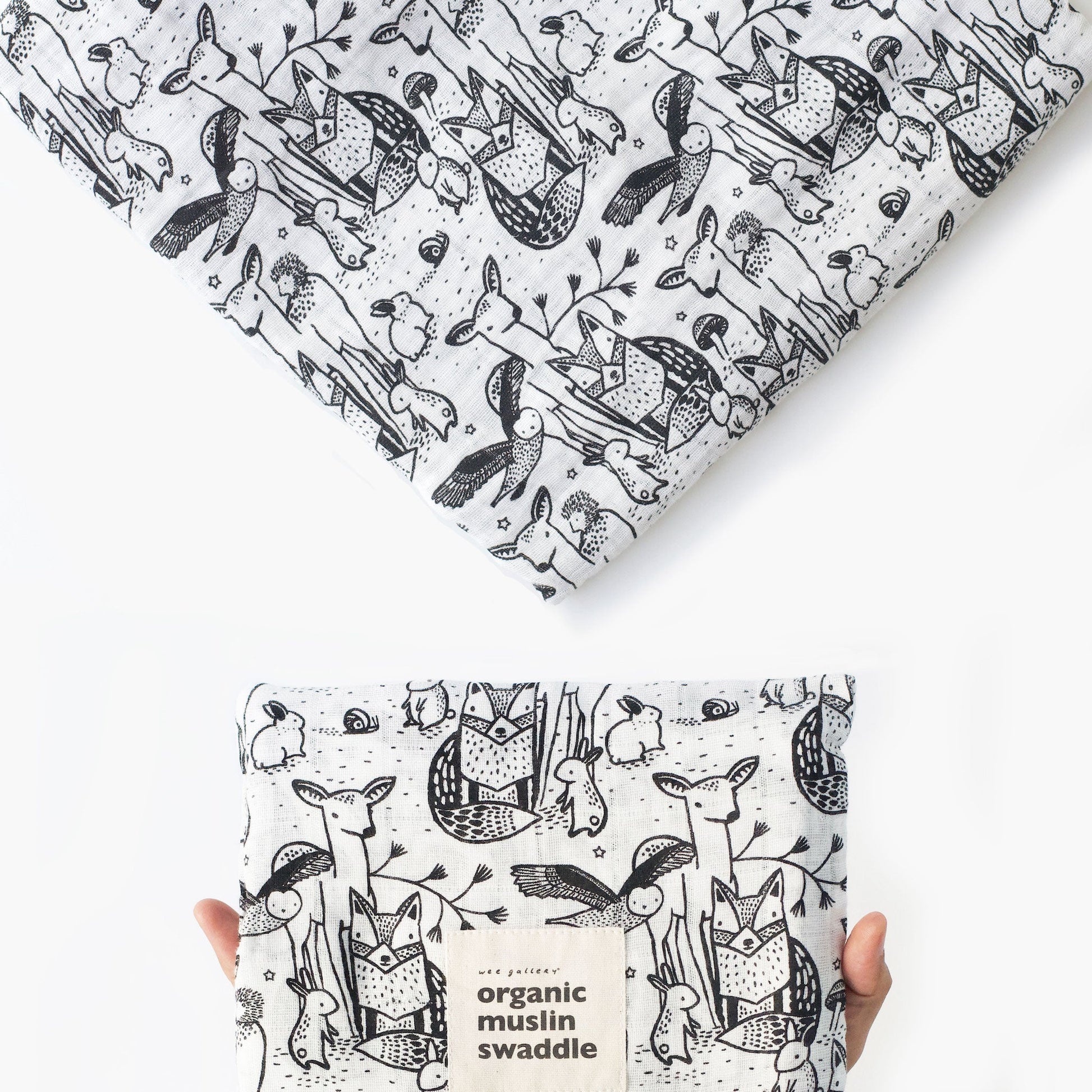 Organic muslin swaddle with black and white animal pattern on a white background