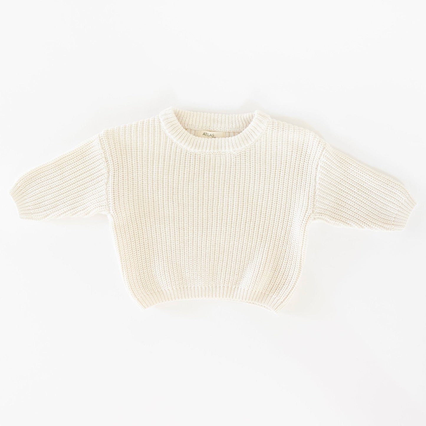Cream-colored ribbed knit top on a white background