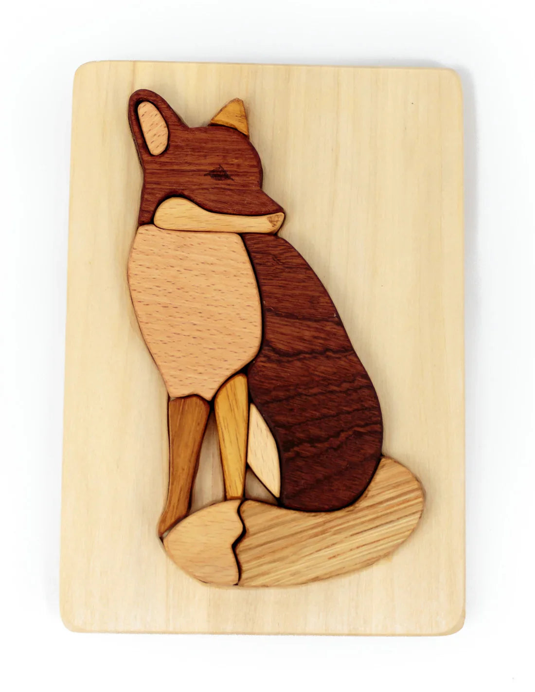 Wooden fox puzzle on a white background