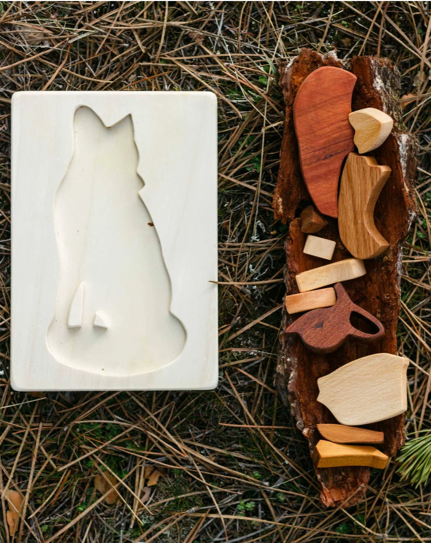 Wooden animal mold and wooden animal figures on a natural background