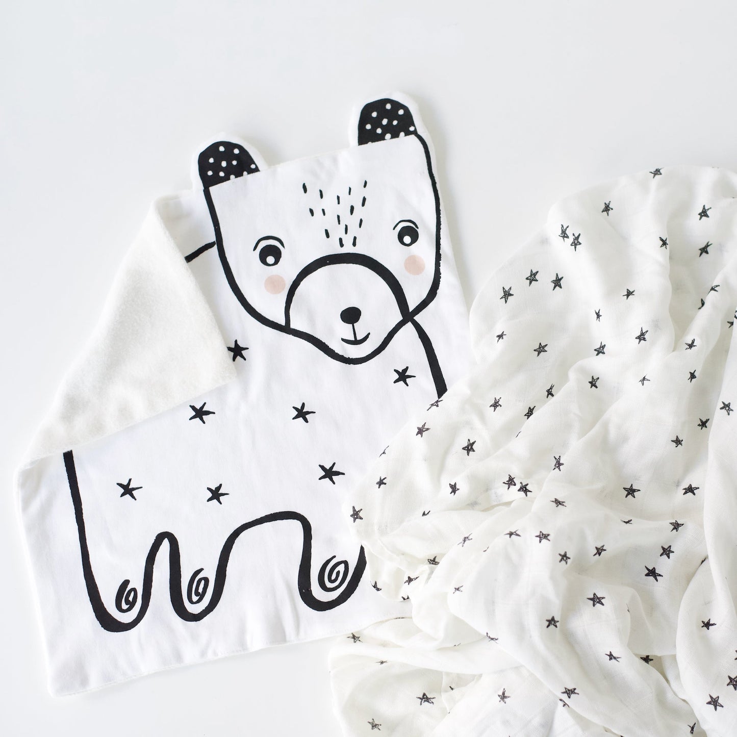 White blanket with black bear design on a white background
