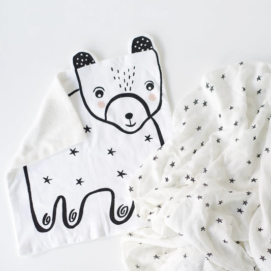 White blanket with black bear design on a white background