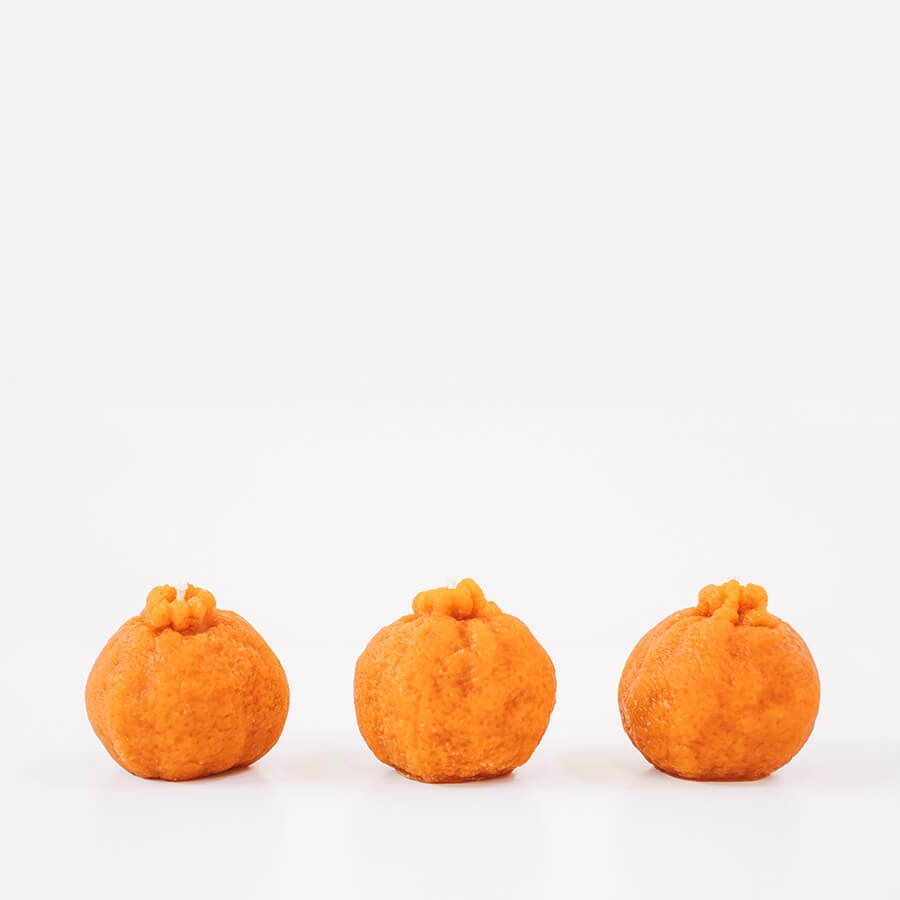 Three small pumpkins on a white background
