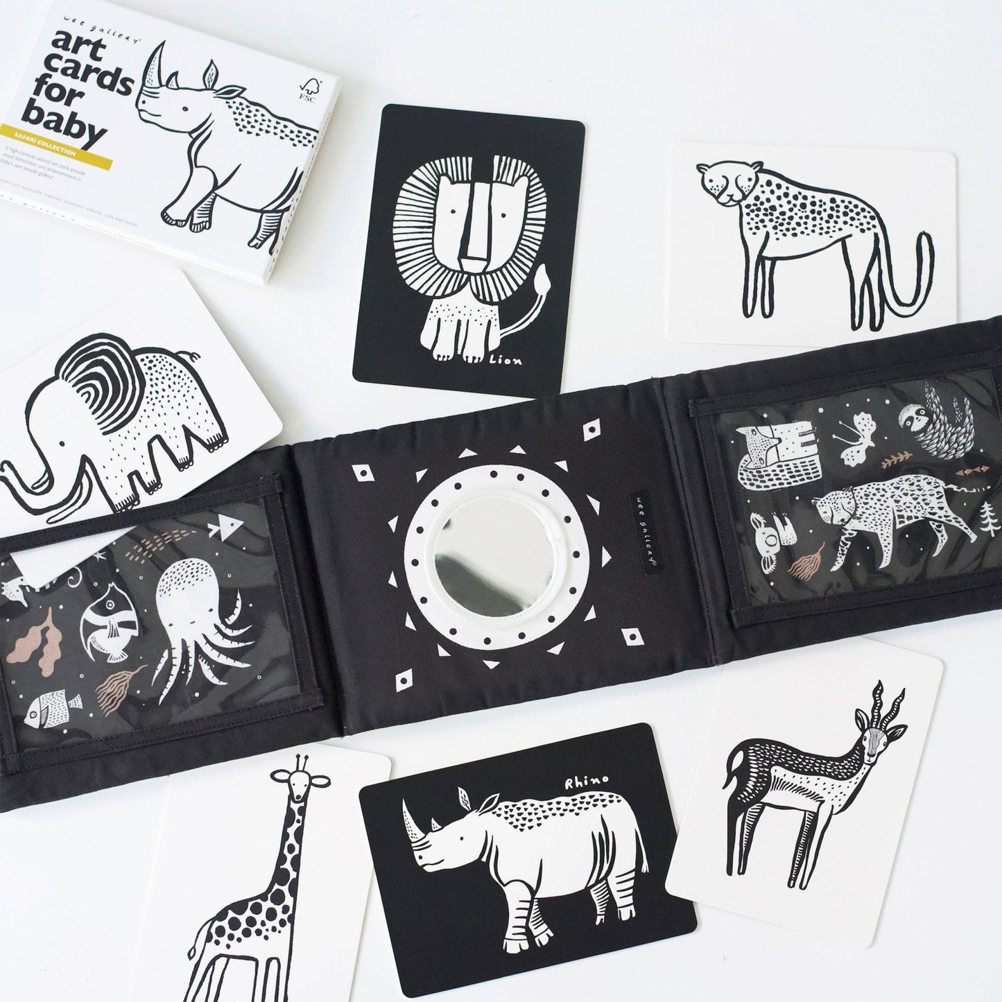 Collection of black and white animal illustrations on cards and a book.