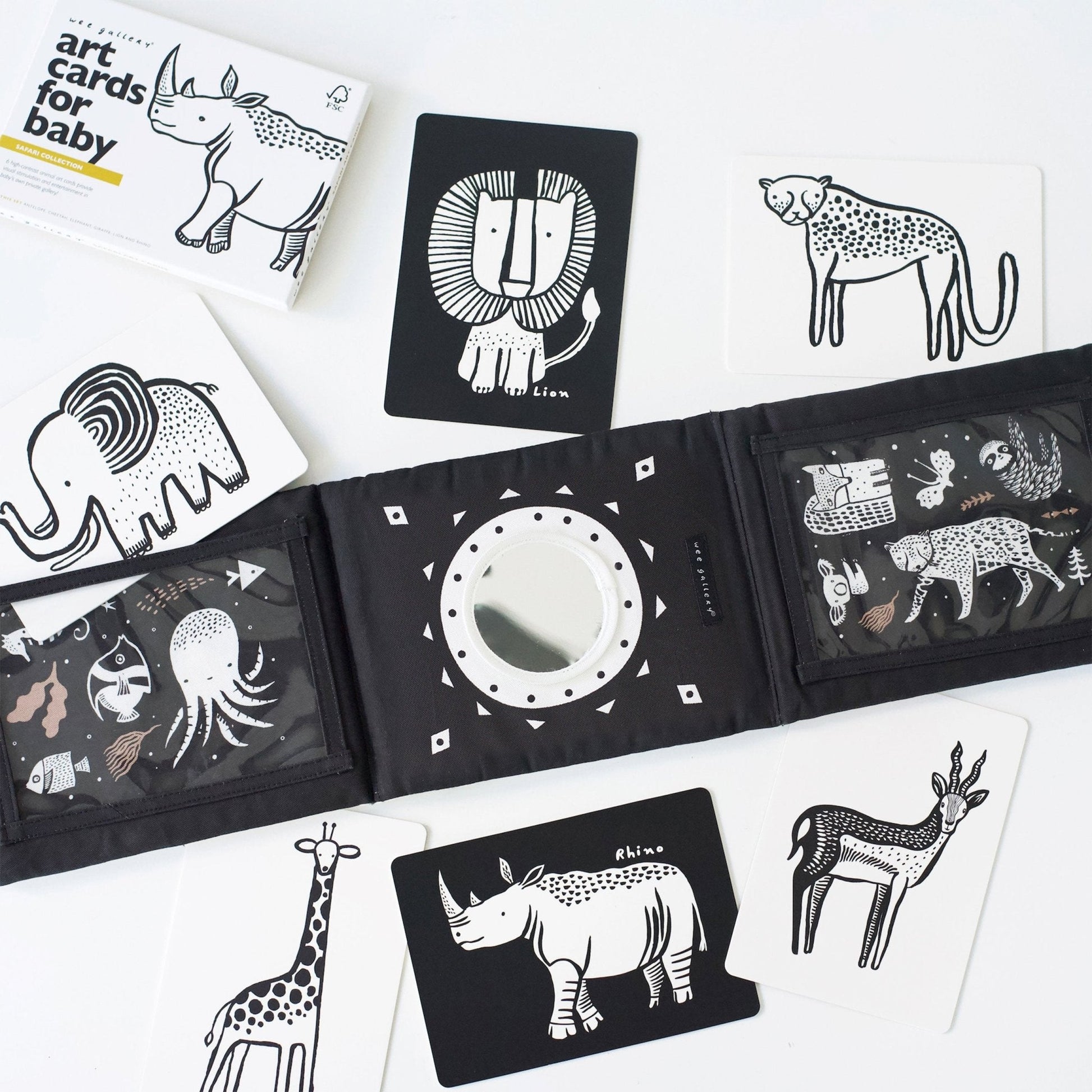 Collection of black and white animal illustrations on cards and a book.